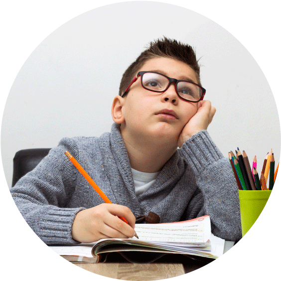 Young boy with glasses holding a pencil.